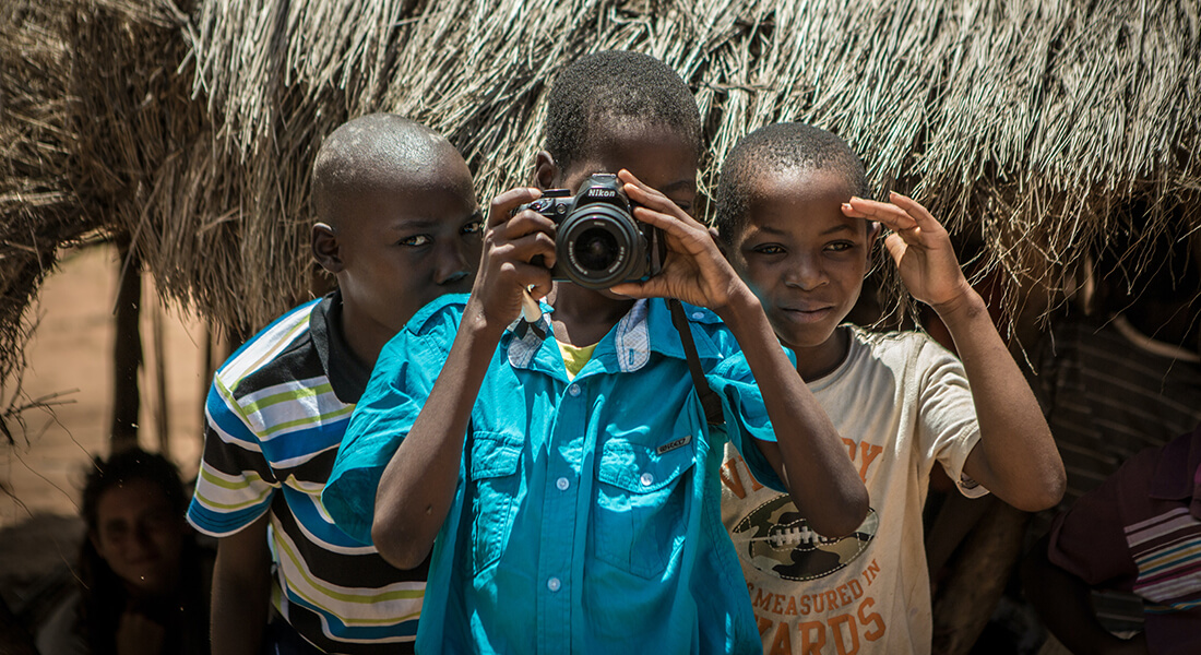 Three boys with a camera